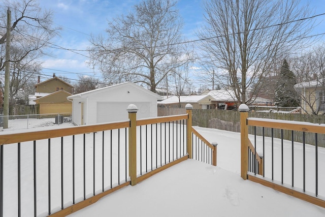 snow covered deck with an outbuilding and a garage