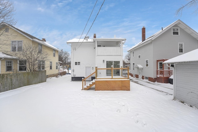 view of snow covered back of property