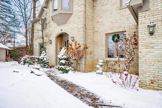 view of snow covered property entrance