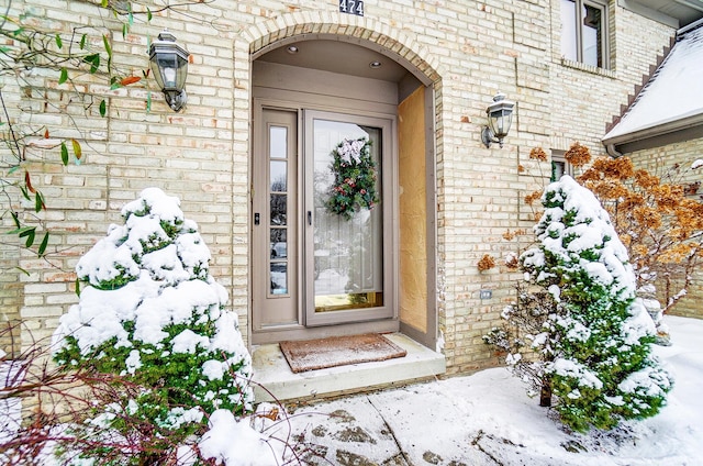 view of snow covered property entrance