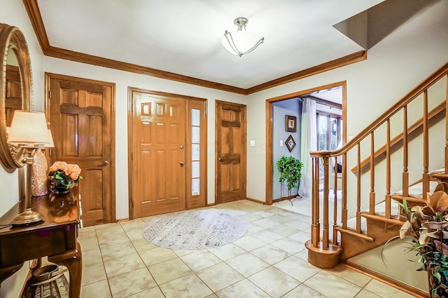 tiled entrance foyer featuring ornamental molding