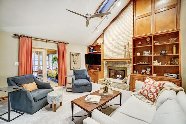 carpeted living room with ceiling fan, a fireplace, and high vaulted ceiling