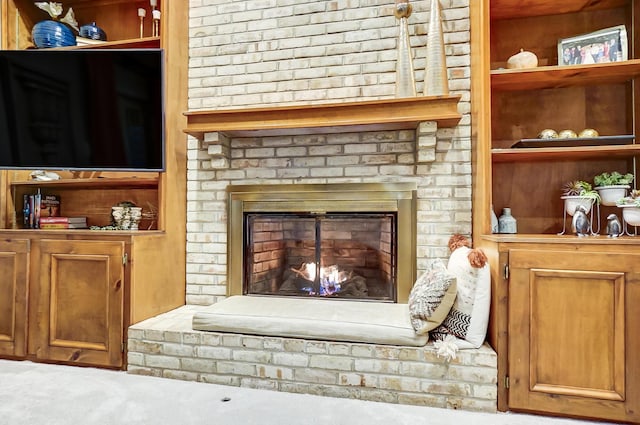 interior details with built in shelves and a fireplace