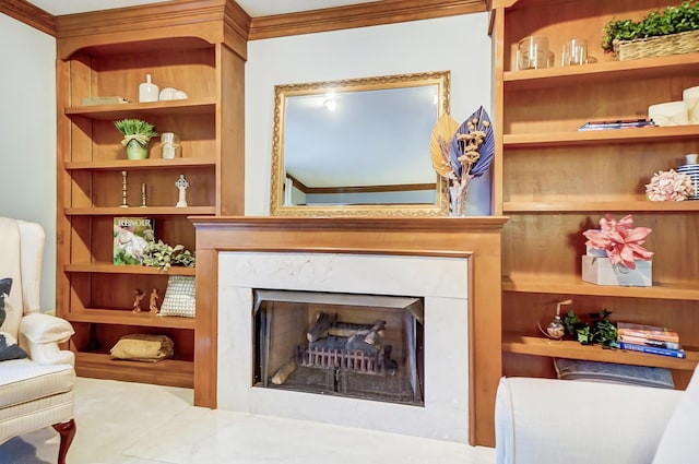 living area featuring a high end fireplace, built in features, and ornamental molding