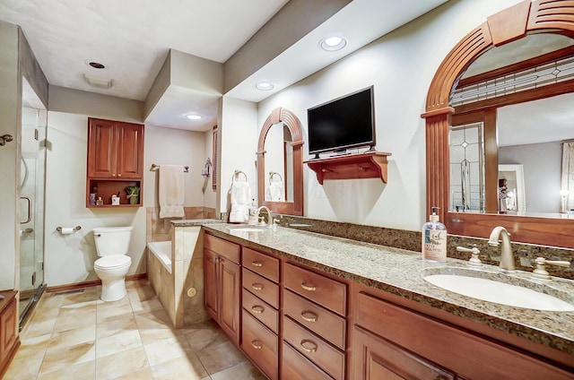 bathroom with tile patterned floors, vanity, toilet, and a shower with shower door