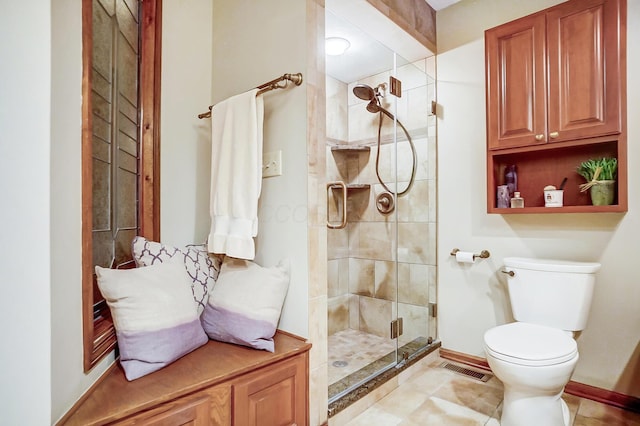 bathroom featuring an enclosed shower and toilet