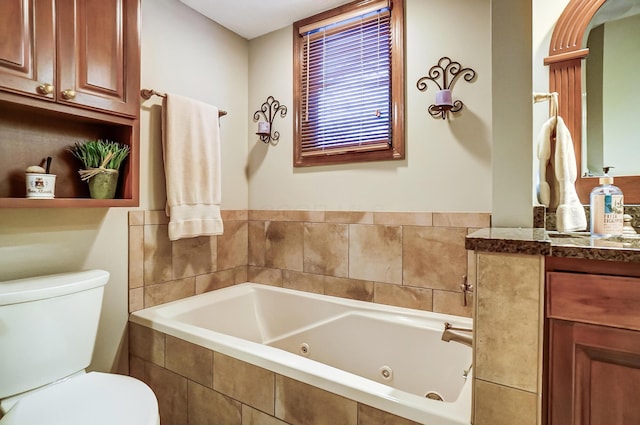 bathroom with vanity, tiled bath, and toilet