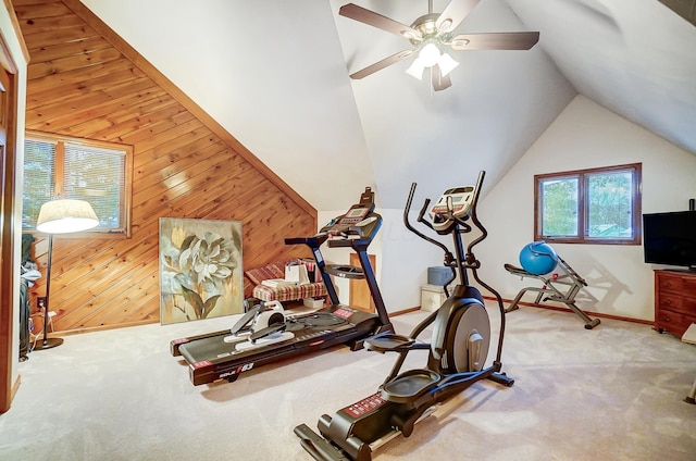 exercise room with light carpet, wooden walls, ceiling fan, and lofted ceiling