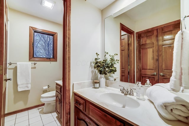 bathroom featuring tile patterned floors, vanity, and toilet