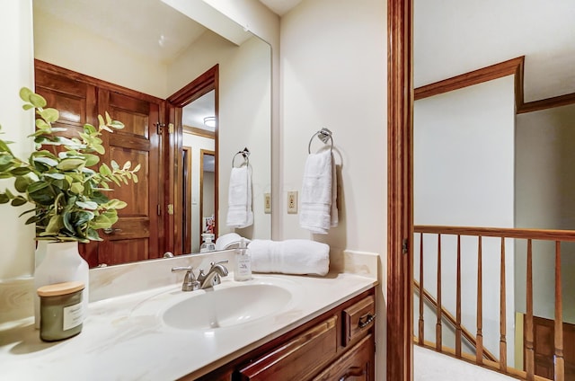 bathroom featuring vanity and ornamental molding