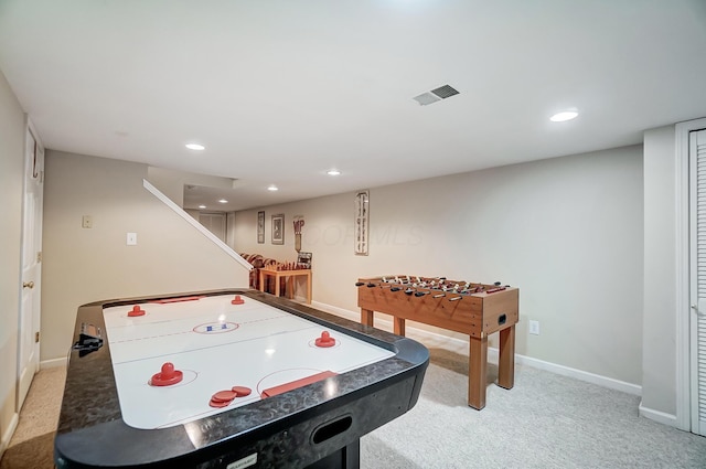 recreation room featuring light carpet