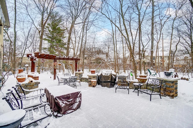 snow covered patio featuring a grill