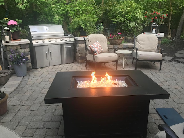 view of patio / terrace featuring area for grilling and an outdoor fire pit