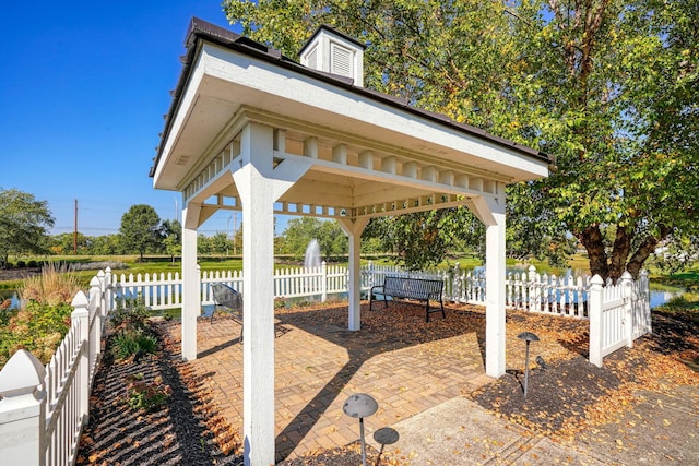 view of patio / terrace with a gazebo and a water view