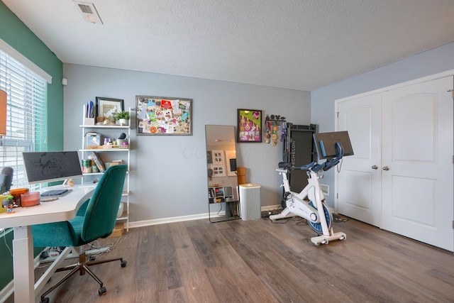 office area featuring wood-type flooring and a textured ceiling