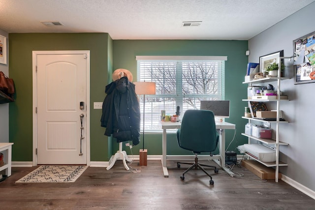 home office featuring a textured ceiling and dark hardwood / wood-style flooring