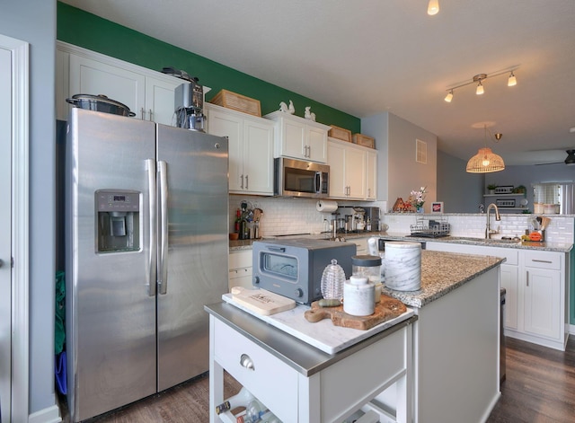 kitchen with white cabinetry, a center island, and appliances with stainless steel finishes