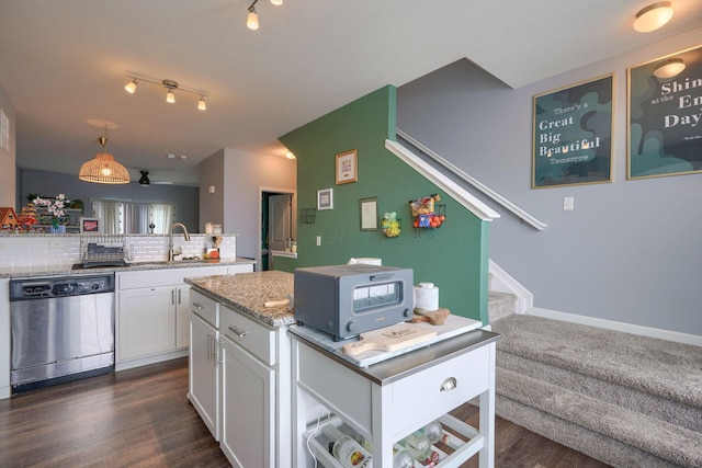 kitchen with dishwasher, dark wood-type flooring, backsplash, decorative light fixtures, and white cabinets