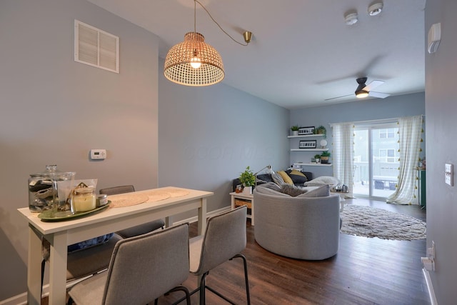 dining space featuring ceiling fan and dark hardwood / wood-style flooring