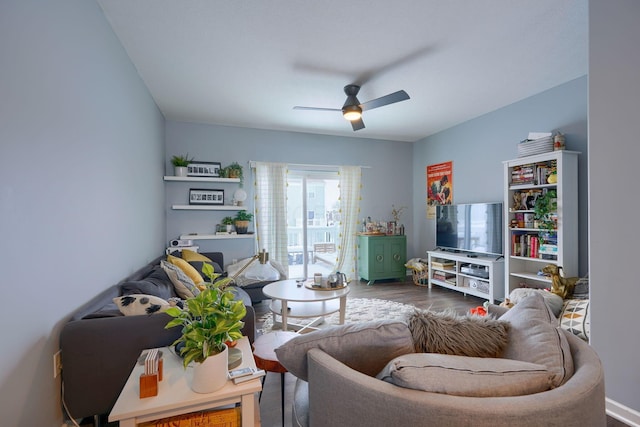 living room with dark hardwood / wood-style flooring and ceiling fan