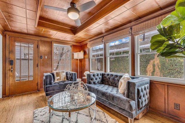 living room featuring wood walls, ceiling fan, wood ceiling, and light wood-type flooring