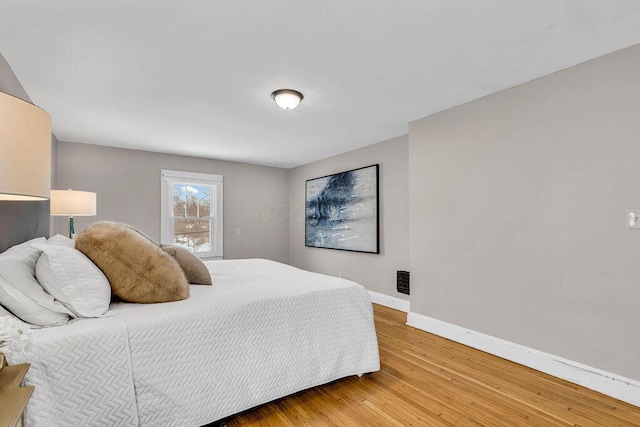 bedroom with hardwood / wood-style flooring