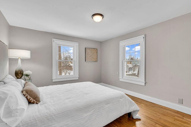 bedroom with hardwood / wood-style flooring