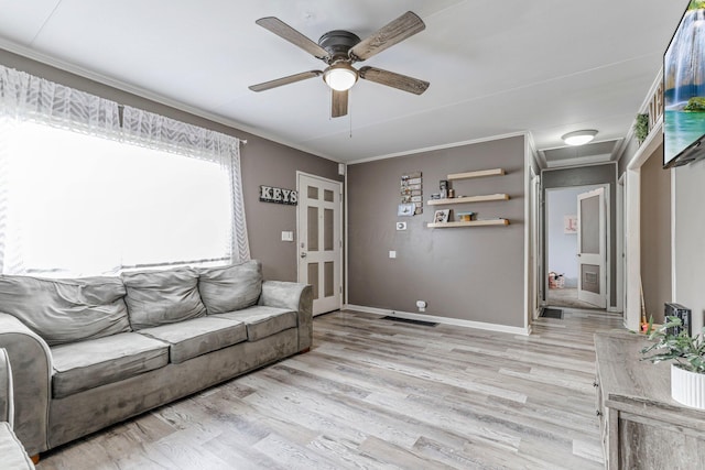 living room with ceiling fan, ornamental molding, and light wood-type flooring