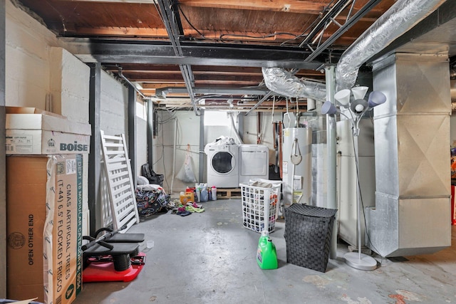 basement with separate washer and dryer, water heater, and heating unit