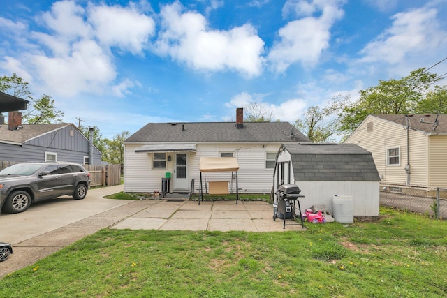 rear view of property with a lawn and a patio area