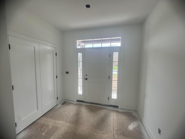 foyer featuring baseboards