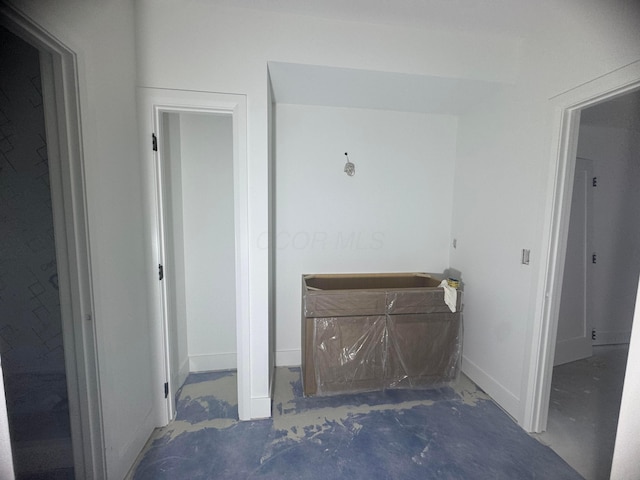 hallway featuring baseboards