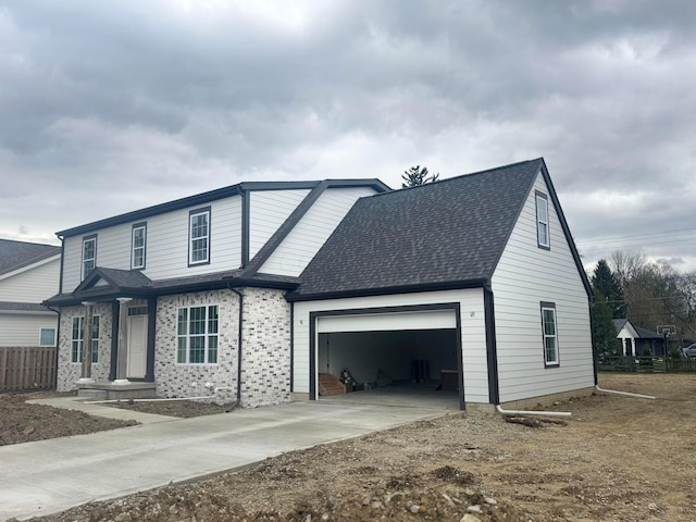view of front of house featuring fence, driveway, brick siding, roof with shingles, and a garage