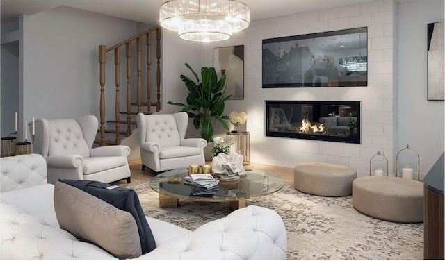 living area with a chandelier, stairway, a fireplace, and wood finished floors