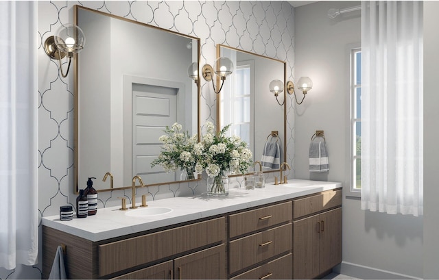 bathroom featuring double vanity, a healthy amount of sunlight, and a sink