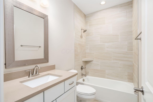 bathroom featuring toilet, tub / shower combination, and vanity