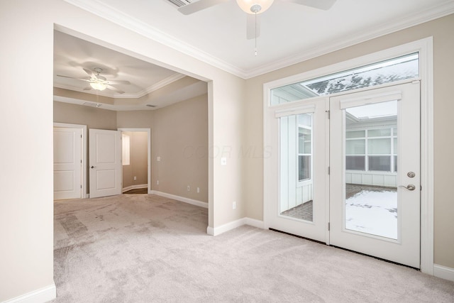 interior space with light carpet, ceiling fan, ornamental molding, and baseboards