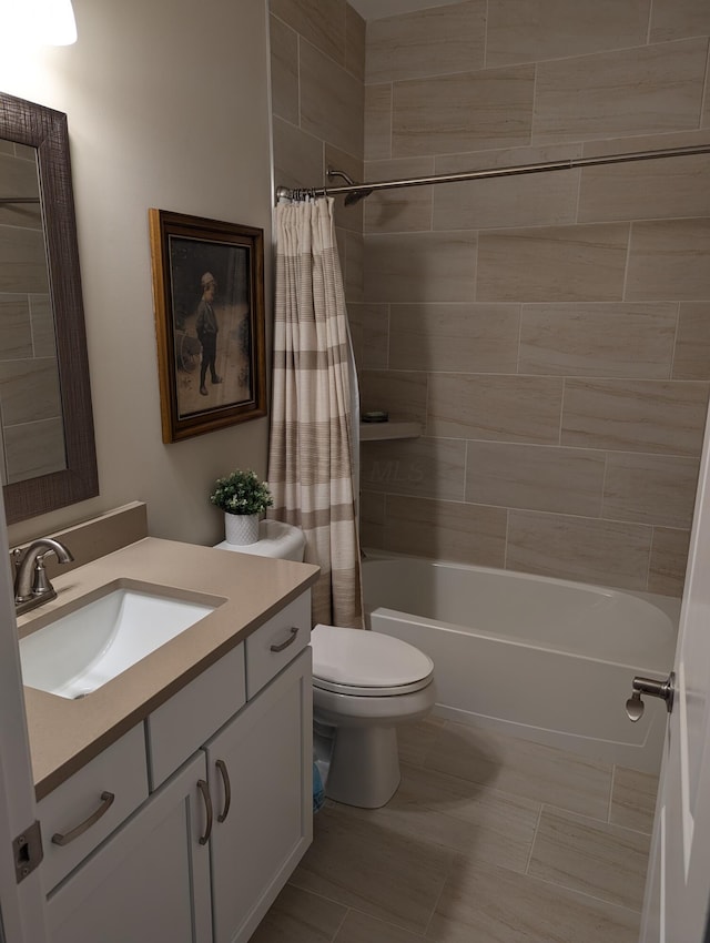 bathroom featuring toilet, shower / tub combo, and vanity