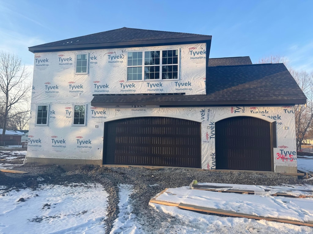 property under construction featuring roof with shingles