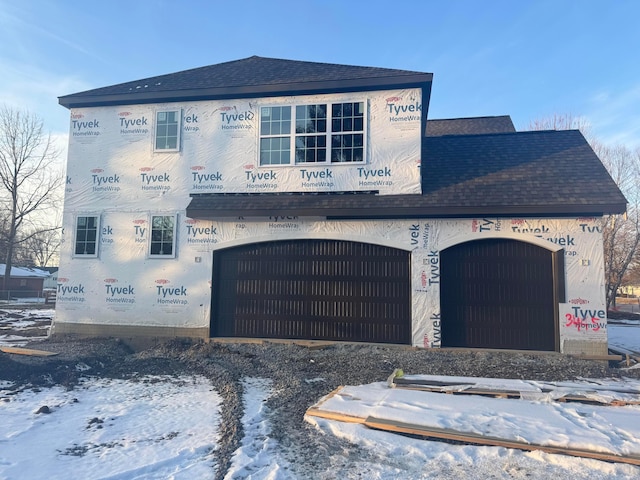 property under construction featuring roof with shingles