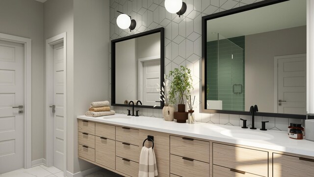 full bathroom with a sink, baseboards, double vanity, and a stall shower