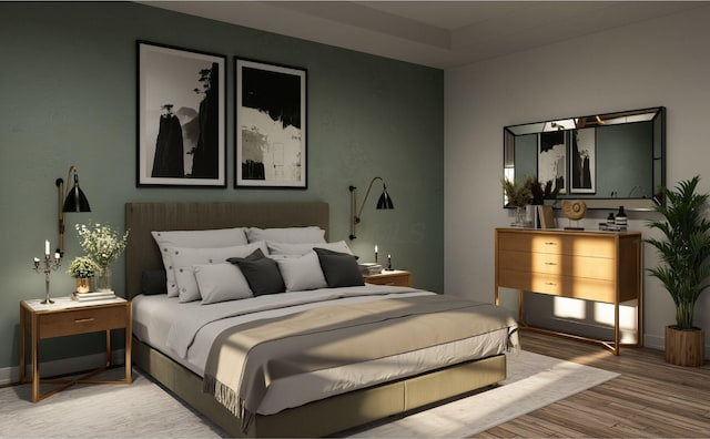 bedroom featuring baseboards and light wood finished floors
