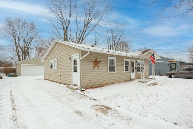 exterior space with an outbuilding and a garage