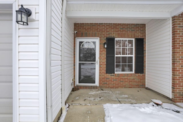 view of snow covered property entrance