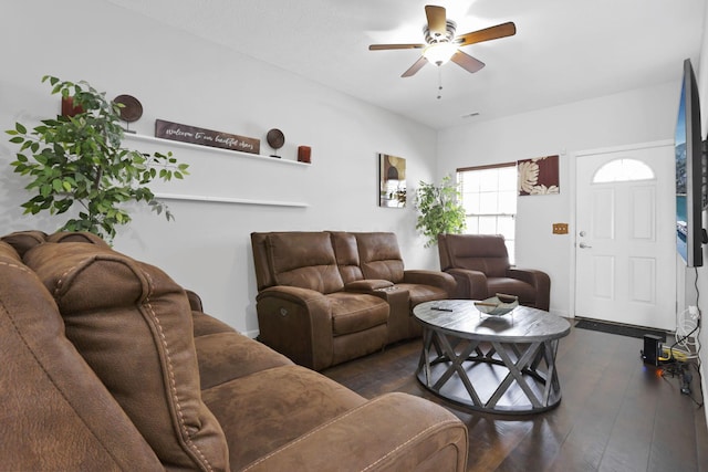 living room with ceiling fan and dark wood-type flooring