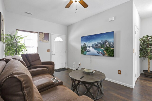 living room with dark hardwood / wood-style flooring and ceiling fan