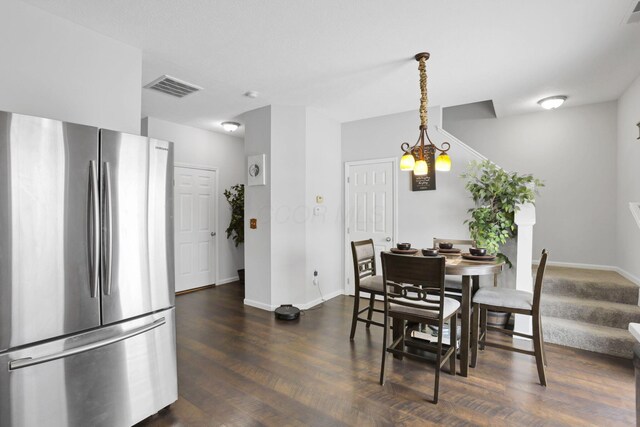 dining room featuring dark hardwood / wood-style floors and a chandelier