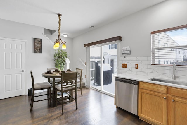 kitchen featuring dishwasher, an inviting chandelier, sink, decorative backsplash, and decorative light fixtures