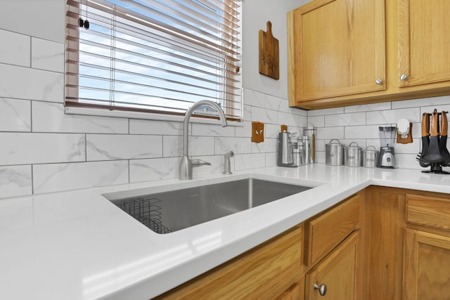 kitchen with backsplash, sink, and a wealth of natural light