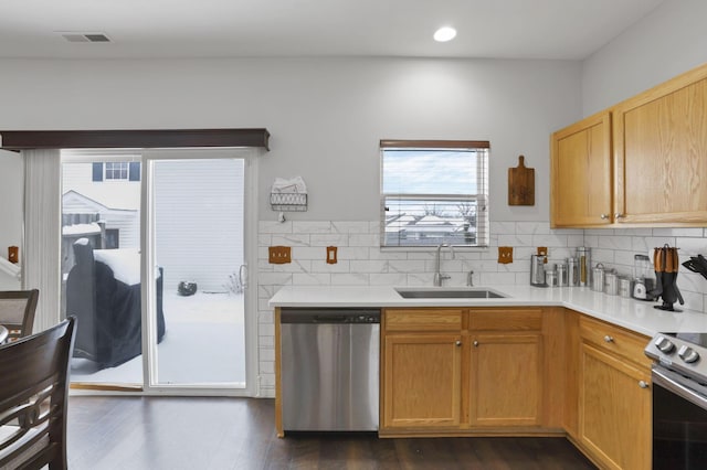 kitchen featuring decorative backsplash, sink, dark hardwood / wood-style floors, and appliances with stainless steel finishes